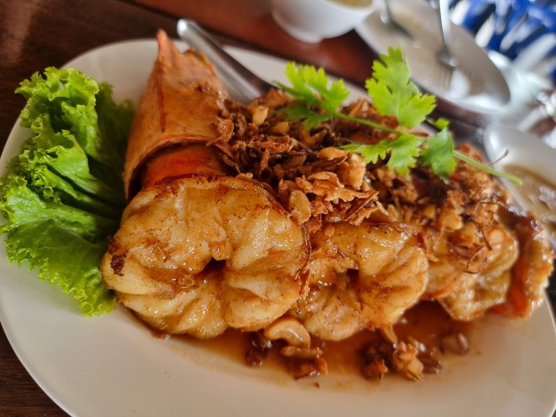 กุ้งตัวโตราดซอสสีส้ม โรยกระเทียมเจียวและผักชี